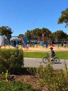 a person riding a bike in a park at Sunset Beach Holiday Park in Geraldton