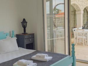 a bedroom with a bed with two towels on it at Fedora Otel Alaçatı in Alaçatı