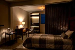 a hotel room with a bed and a desk and a desk at Santa Martha Hotel Boutique in Progreso de Obregón +2 photos