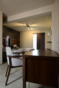 a room with two beds and a desk with a chair at Santa Martha Hotel Boutique in Progreso de Obregón