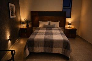 a bedroom with a large bed with two night stands at Santa Martha Hotel Boutique in Progreso de Obregón