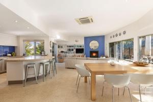 a kitchen and living room with a table and chairs at Indigo Blue in Robe