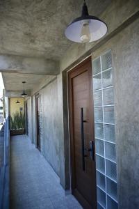 a hallway with a wooden door in a house at Santa Martha Hotel Boutique in Progreso de Obregón