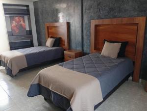 a hotel room with two beds in a room at Santa Martha Hotel Boutique in Progreso de Obregón