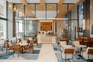 a lobby of a restaurant with tables and chairs at Four Points by Sheraton Nha Trang in Nha Trang
