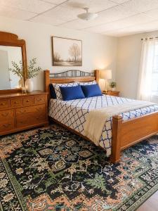 a bedroom with a bed and a dresser and a mirror at Fall River Stay Urban Haven Entire Suites Cozy 4BR in Fall River