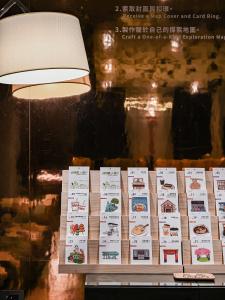a table with a lamp and some signs on it at CHECK inn HIVE in Luodong