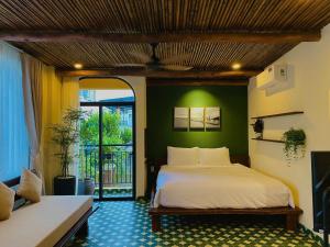 a bedroom with a bed and a green wall at Staypineapple in Quy Nhon +13 photos