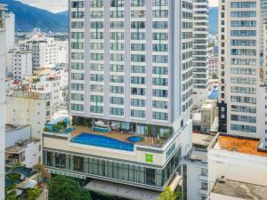 an aerial view of a tall building with a pool at ibis Styles Nha Trang in Nha Trang