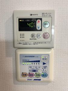 an electronic device with buttons and controls on a wall at 一心館sakura401 in Wada