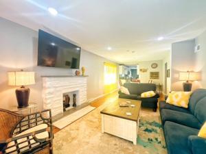 a living room with a couch and a fireplace at Triple Crown KC in Kansas City