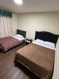 a hotel room with two beds and a window at Flamante Atardecer in Paracas
