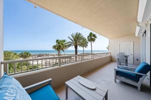 a living room with a view of the beach at 2BR Beach Condo Shared Pool Tennis Courts in Gulf Shores