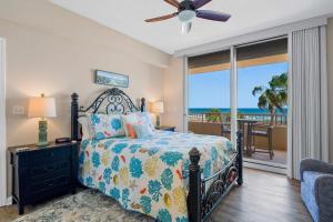 a bedroom with a bed and a balcony with the ocean at 2BR Beach Condo Shared Pool Tennis Courts in Gulf Shores