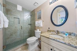 a bathroom with a shower and a toilet and a sink at 2BR Beach Condo Shared Pool Tennis Courts in Gulf Shores