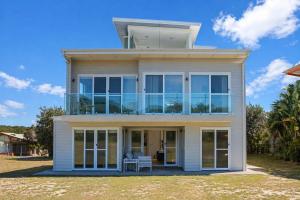 a house with large windows on the front of it at The Lookout in Diamond Beach
