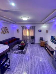 a living room with a couch and a tv at AmkGroup in Dakar