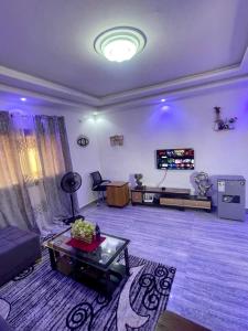 a large living room with a couch and a tv at AmkGroup in Dakar