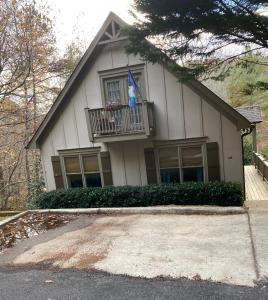 a house with a balcony and a flag on it at Chalet Suzanne in Helen