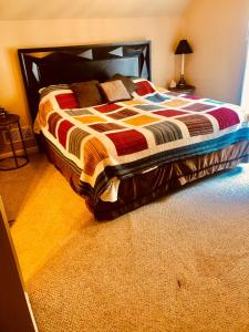 a bedroom with a bed with a colorful comforter at Chalet Suzanne in Helen