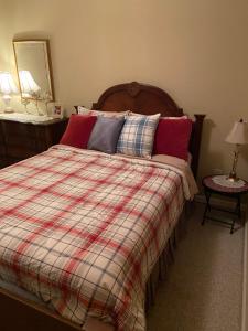 a bedroom with a bed with a plaid blanket at Chalet Suzanne in Helen +6 photos