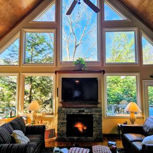 a living room with a fireplace and a tv at Chalet Suzanne in Helen