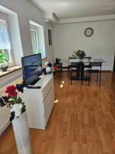 a living room with a desk with a computer on it at Premium Home 2 in Busingen am Hochrhein