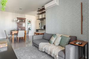 a living room with a couch and a table at Apt Boutique Grande Florianópolis - Sua Estadia SC in São José