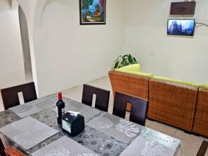 a dining room with a table with a bottle of wine on it at Alinas House in Fortuna