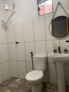 a bathroom with a toilet and a sink at Pousada Portal D'amaro in Santo Amaro