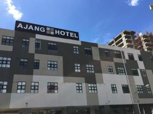 a building with a hotel sign on top of it at Ajang Hotel in Miri