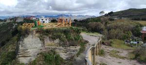a dirt road with a bridge on a mountain at Urku Ñan Quilotoa in Sigchos +17 photos