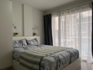 a bedroom with a bed and a large window at Mae Phim beach in Ban Tha Fat +14 photos