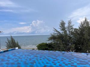 a swimming pool with a view of the ocean at Mae Phim beach in Ban Tha Fat