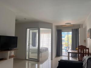 a living room with a bed and a mirror at Mae Phim beach in Ban Tha Fat