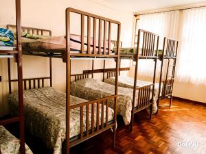 a room with three bunk beds in a room at Casa Betania in La Paz