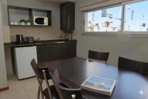 a kitchen with a table with a book on it at Rosario Temporal in Rosario