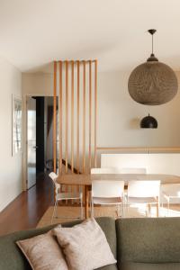 a living room with a couch and a table and chairs at Bay Properties The Big Chill in Yamba