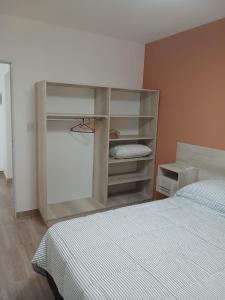 a bedroom with a bed and a book shelf at Listo para vos in RSA
