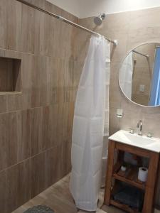 a bathroom with a shower curtain and a sink at Listo para vos in RSA