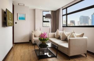 a living room with a couch and a table at Clover Hotel Monivong in Phnom Penh