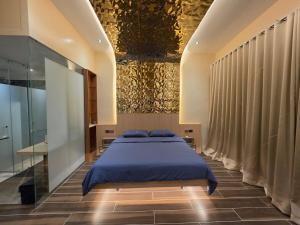 a bedroom with a bed with a blue comforter at Dream View Villa Samal in Samal +60 photos