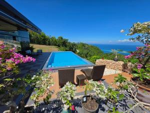 a villa with a swimming pool and the ocean at Dream View Villa Samal in Samal
