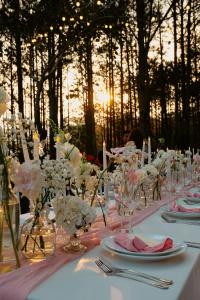 a table with white and pink flowers on it at Binh An Village Resort in Da Lat