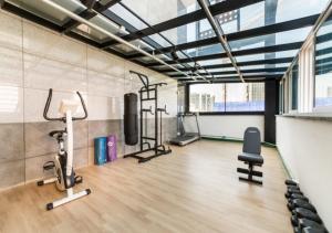 a gym with treadmills and exercise equipment in a room at Gimpo Pentastar Hotel in Gimpo
