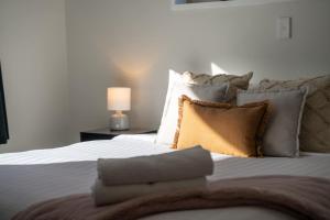a bedroom with a white bed with pillows at Haven on Molyneux in Cromwell