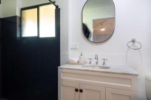a bathroom with a sink and a mirror at Rundle & Salt in Ulladulla +22 photos