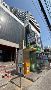 a gas station in front of a building at omni1818 in Bang Kapi