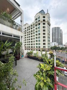 a view of a building with plants on a balcony at Jazz Living - Tropical Apartment 5 minutes walk from landmark 81 in Ho Chi Minh City