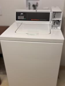 a toaster oven on top of a white refrigerator at Days Inn by Wyndham Fargo - West Acres in Fargo
